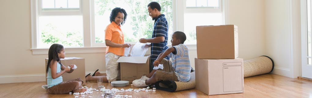 Family packing boxes to represent moving
